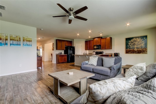 living room featuring hardwood / wood-style flooring and ceiling fan