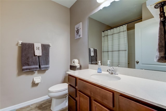 bathroom featuring vanity, hardwood / wood-style floors, and toilet