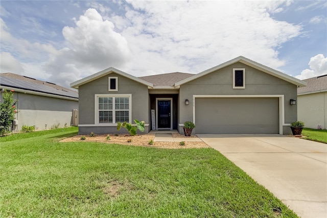 single story home featuring a front lawn and a garage