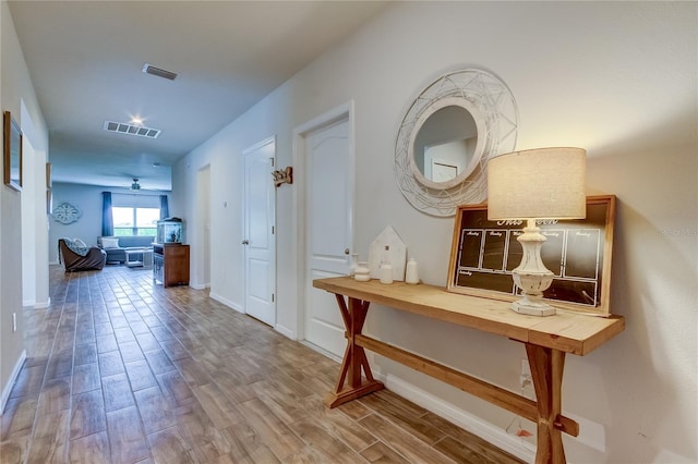 corridor with hardwood / wood-style floors