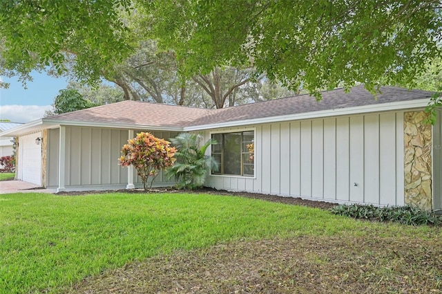 single story home with a front lawn and a garage