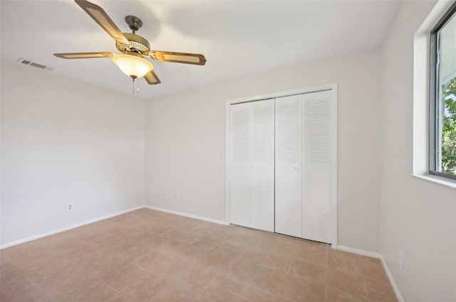 unfurnished bedroom with a closet and ceiling fan