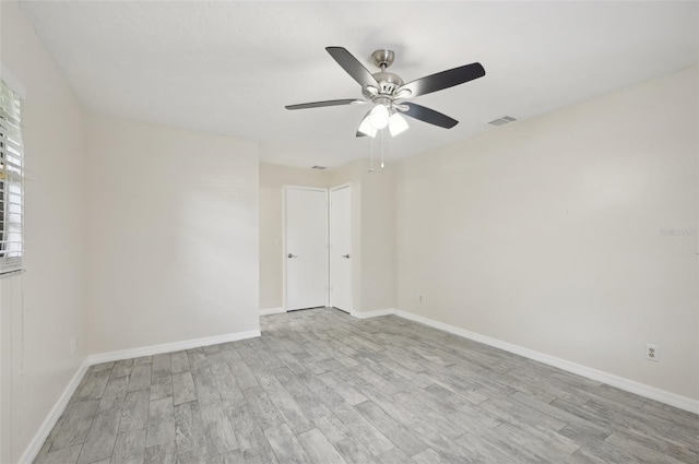 spare room with light wood-type flooring and ceiling fan