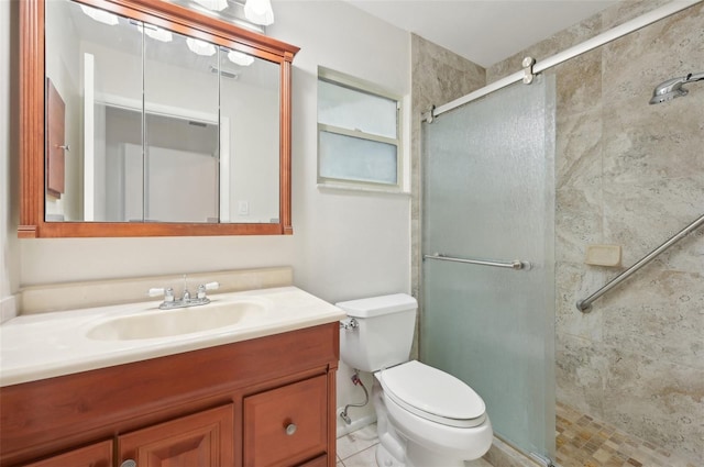 bathroom with tile patterned flooring, walk in shower, toilet, and vanity