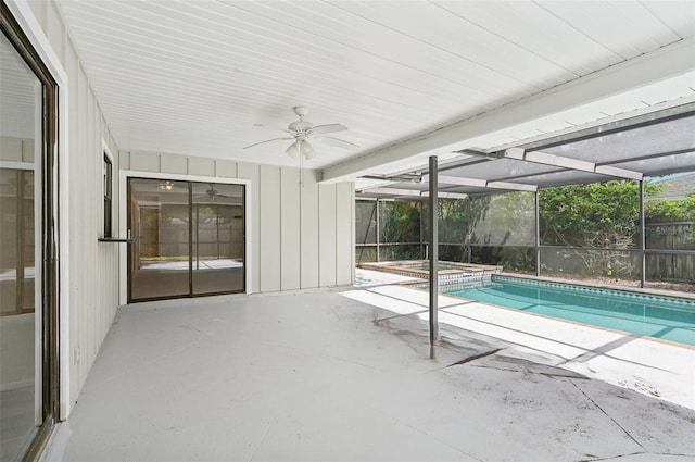 view of swimming pool with a patio area and glass enclosure