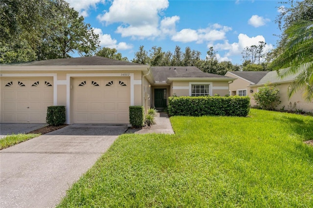 ranch-style house with a garage and a front lawn