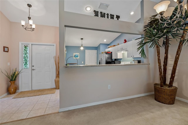 interior space featuring high vaulted ceiling, an inviting chandelier, and sink