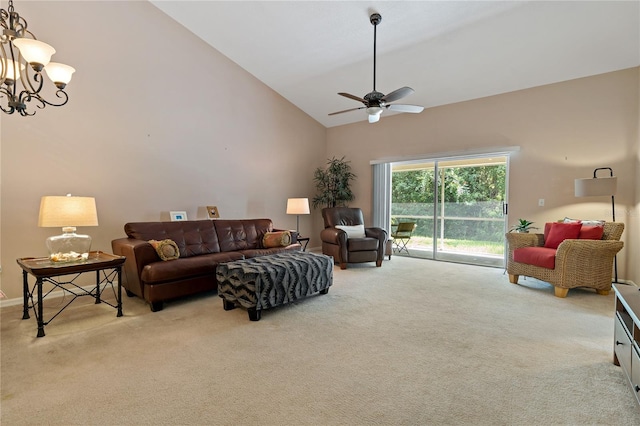 carpeted living room with ceiling fan with notable chandelier and high vaulted ceiling