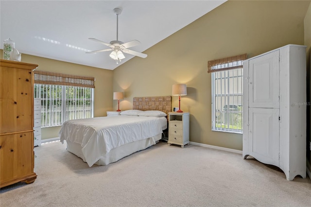 bedroom featuring vaulted ceiling, carpet, ceiling fan, and multiple windows