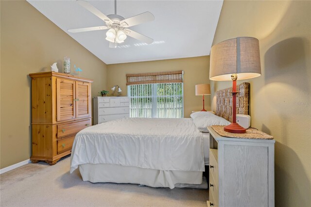 bedroom with lofted ceiling, ceiling fan, and light carpet