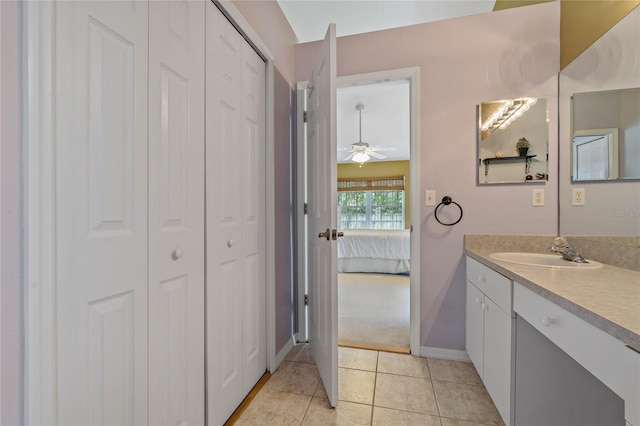 bathroom with tile patterned flooring, vanity, and ceiling fan