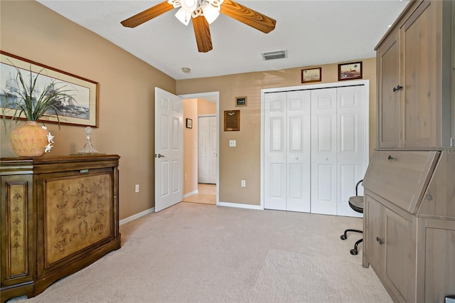 carpeted office with ceiling fan