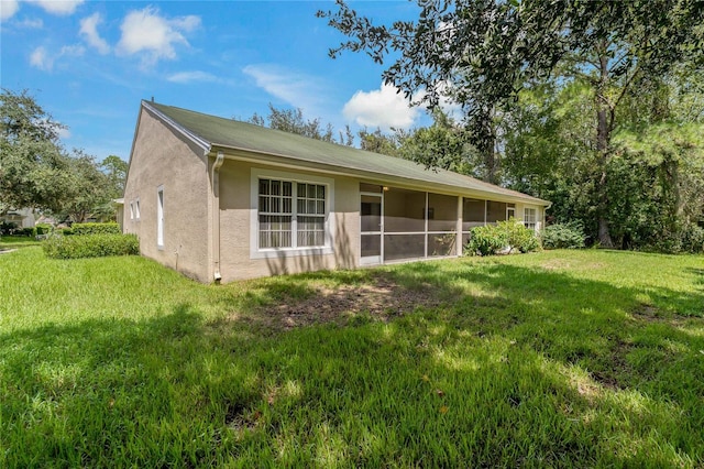 rear view of property with a yard