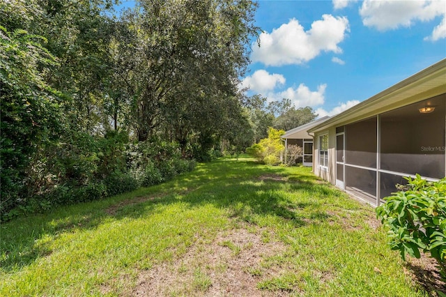 view of yard with a sunroom