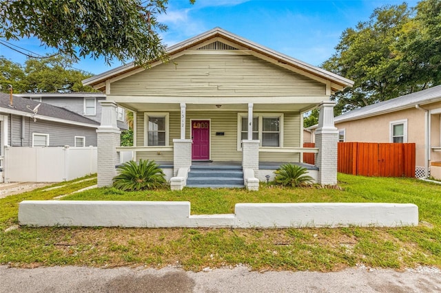 bungalow featuring a front yard and a porch