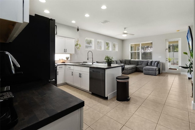 kitchen with kitchen peninsula, ceiling fan, black appliances, sink, and white cabinets