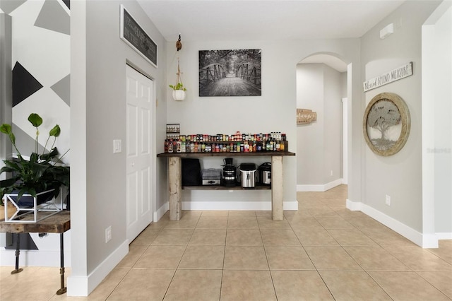 hall with light tile patterned floors