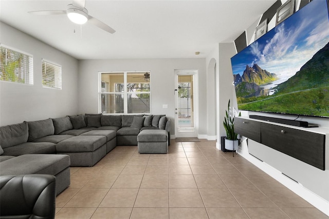 living room featuring ceiling fan and light tile patterned flooring