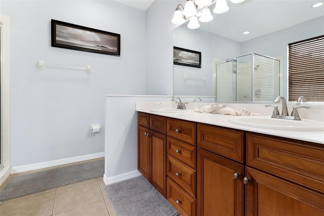 bathroom with tile patterned floors, vanity, and walk in shower