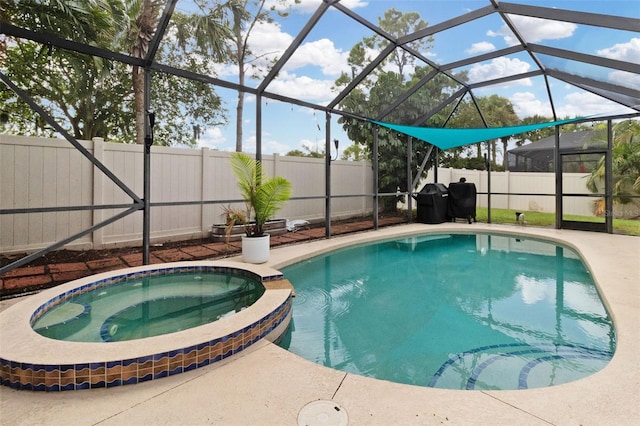 view of pool featuring a patio area, a lanai, and an in ground hot tub