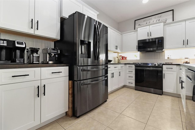 kitchen featuring decorative backsplash, stainless steel fridge, electric stove, white cabinets, and light tile patterned flooring