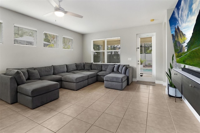 tiled living room featuring ceiling fan