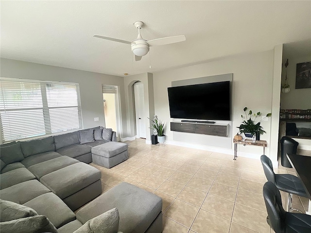 living room with ceiling fan and light tile patterned floors