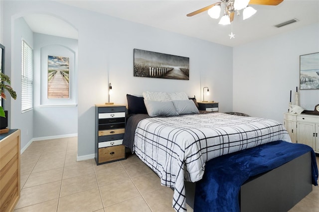 tiled bedroom featuring ceiling fan