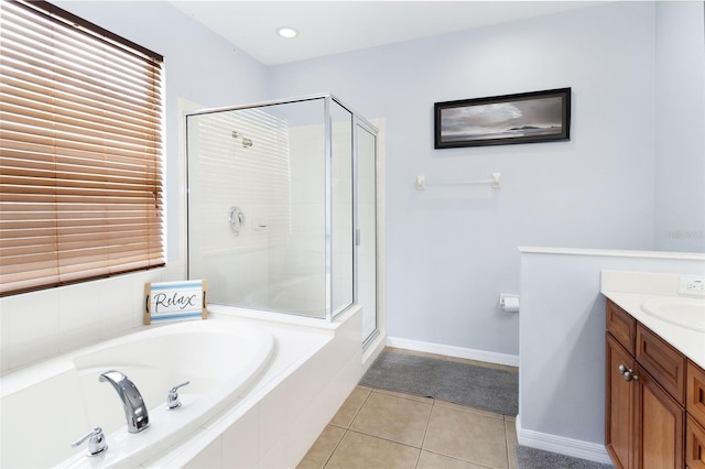 bathroom with tile patterned floors, vanity, and independent shower and bath