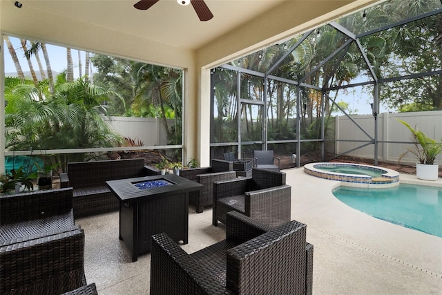 view of swimming pool featuring glass enclosure, a patio area, an in ground hot tub, and an outdoor living space with a fire pit