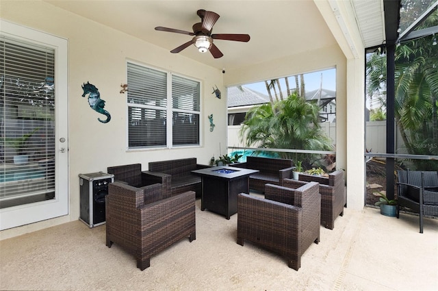 view of patio / terrace with an outdoor living space with a fire pit and ceiling fan