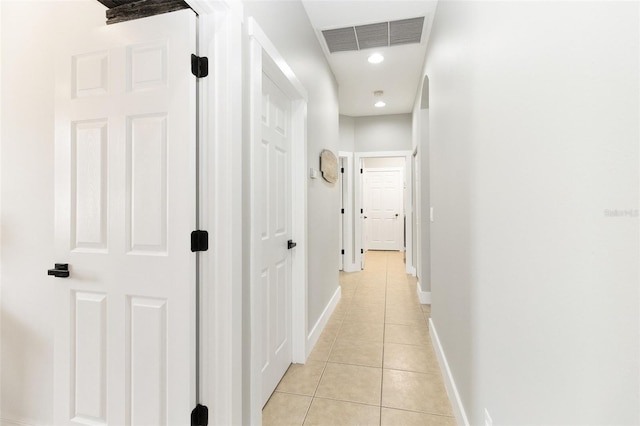 hall featuring light tile patterned flooring