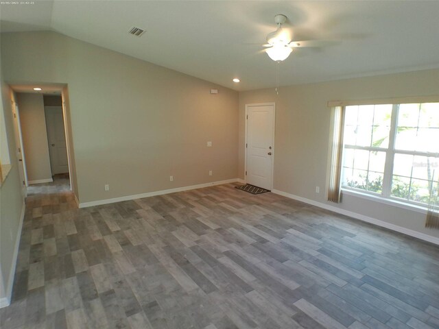 unfurnished room featuring lofted ceiling, ceiling fan, and wood-type flooring