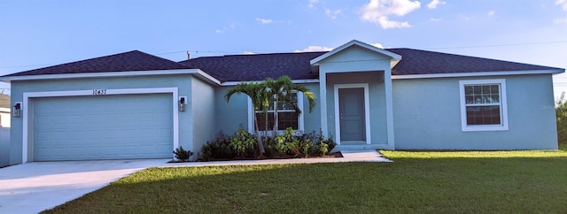 ranch-style home featuring a garage and a front lawn