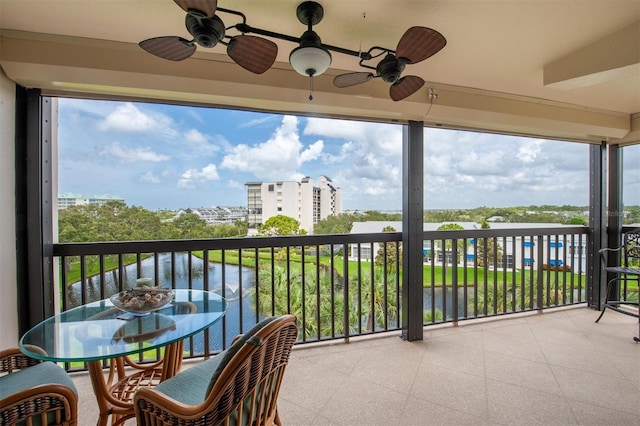 balcony with a water view and ceiling fan