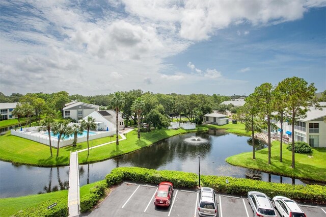 exterior space featuring a water view and a lawn