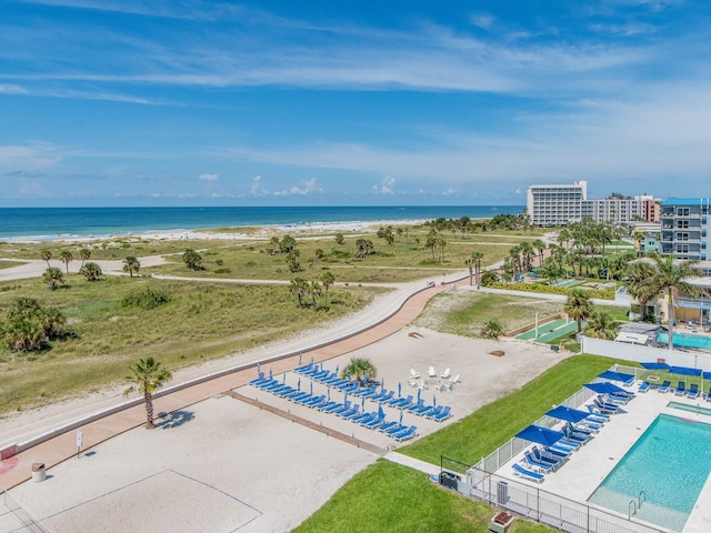 birds eye view of property with a water view and a beach view