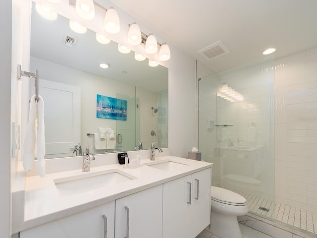 bathroom with vanity, toilet, walk in shower, and tile patterned floors