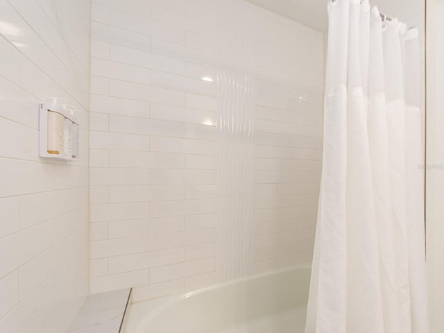 bathroom featuring shower / tub combo with curtain