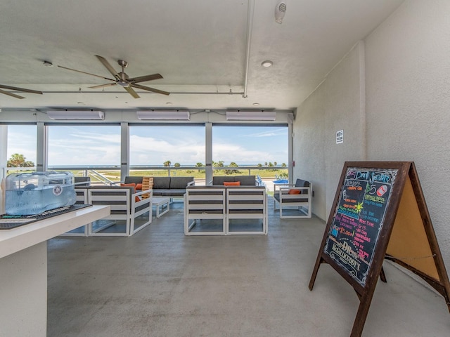 interior space with ceiling fan and a wall mounted air conditioner