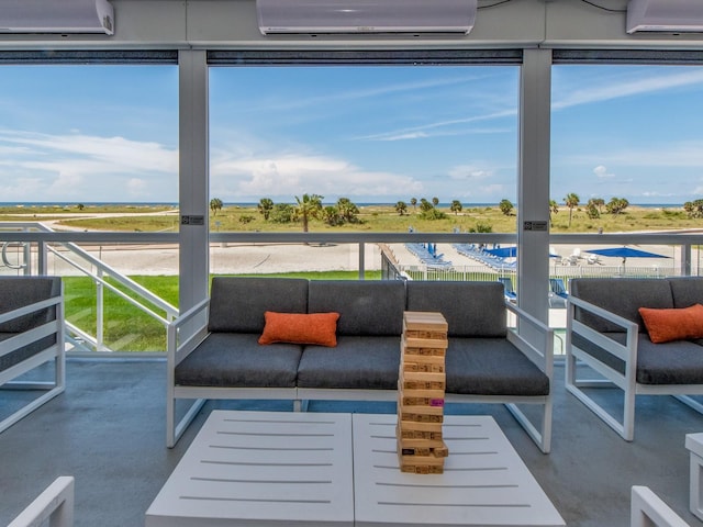 sunroom / solarium featuring a healthy amount of sunlight and a wall mounted air conditioner