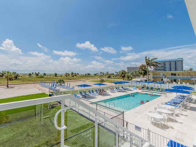 view of swimming pool featuring a patio area and a yard