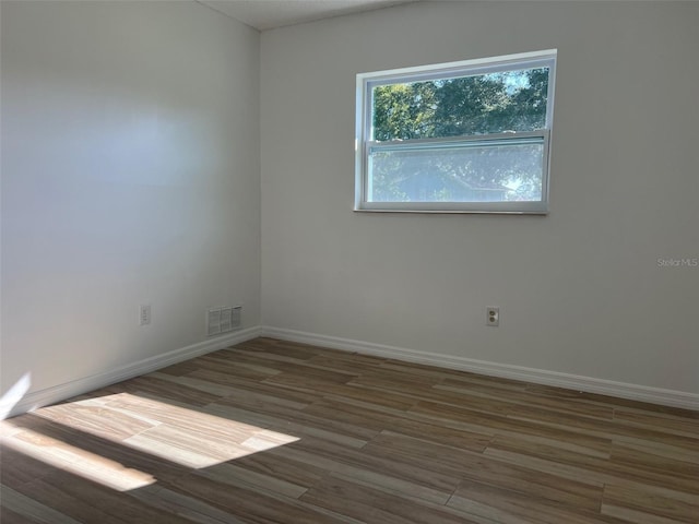 unfurnished room with dark hardwood / wood-style floors