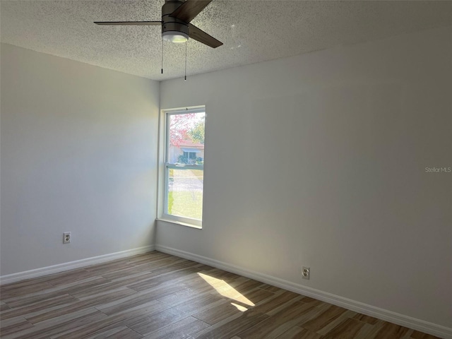 unfurnished room featuring hardwood / wood-style floors, ceiling fan, and a textured ceiling