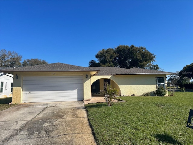 single story home featuring a garage and a front yard