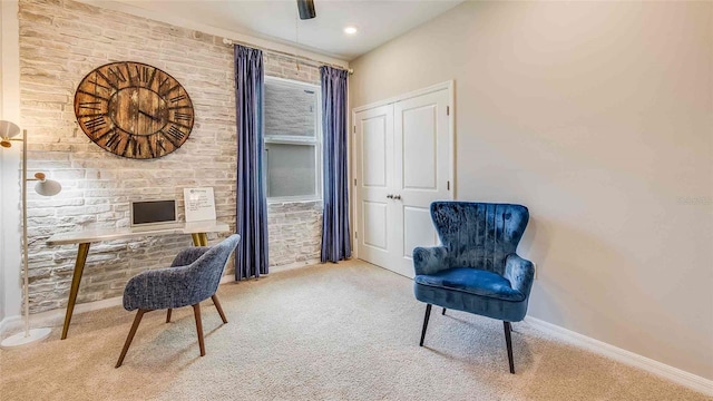 carpeted office space with ceiling fan and baseboards