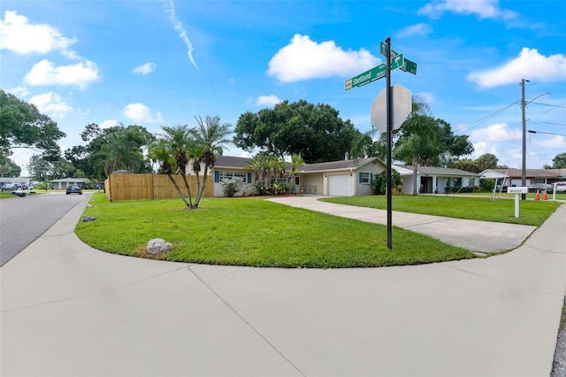 ranch-style house featuring a garage and a front yard