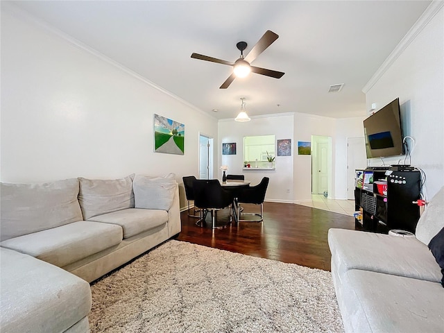 living room featuring ceiling fan, hardwood / wood-style flooring, and ornamental molding