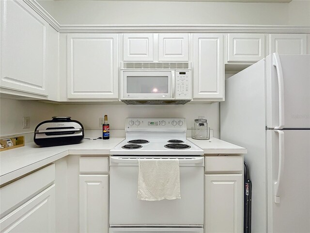 kitchen featuring white appliances and white cabinetry