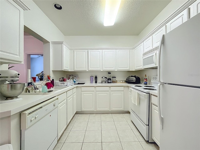 kitchen with white appliances, a textured ceiling, white cabinetry, and light tile patterned flooring